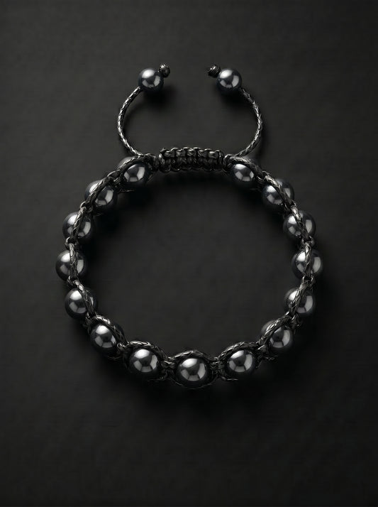 Pulsera PRESENCIA de hematita pulida y tejido negro ajustable